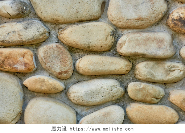 石头堆砌的城墙灰色石墙纹理背景的特写视图  